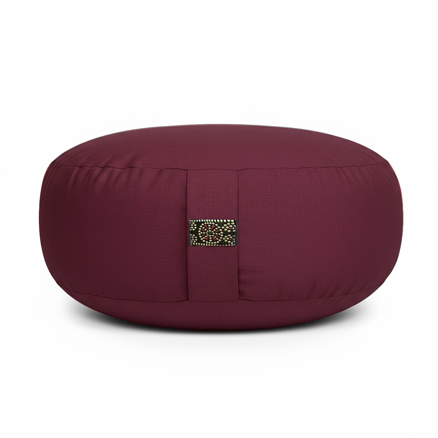 Ein rundes, bordeauxfarbenes Meditationskissen mit verziertem Band.