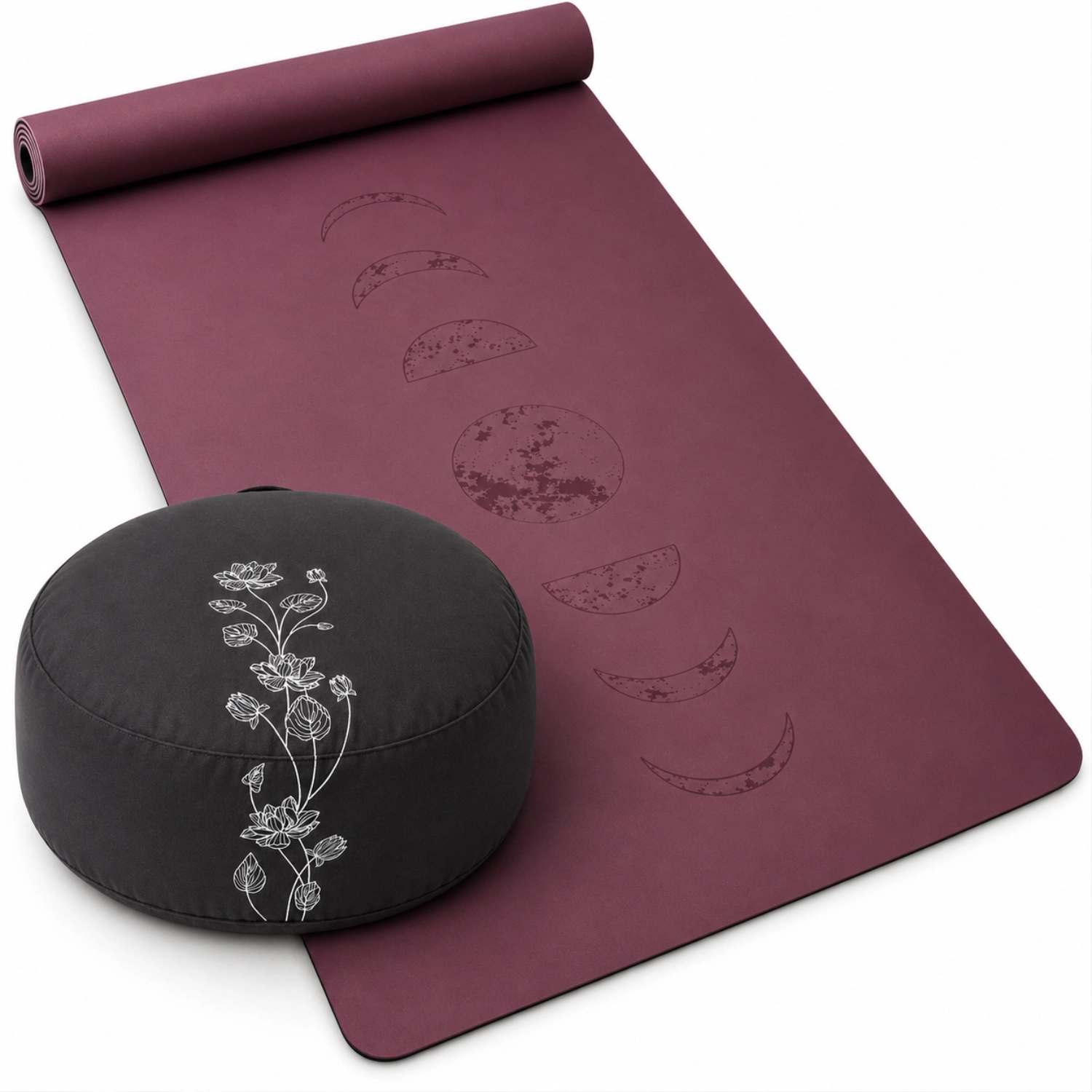 Bordeauxrote Yogamatte mit eingeprägten Mondphasen und schwarzem rundem Meditationskissen mit weißem Blumenmotiv.
